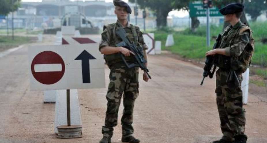 French soldiers stand guard at a checkpoint near Bangui Airport on October 10, 2013.  By Issouf Sanogo AFPFile