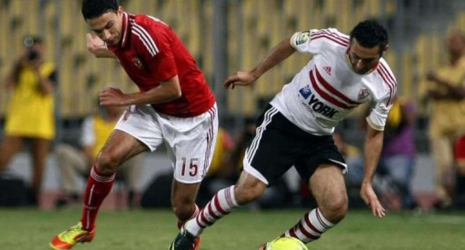 Mohammed Nagi of Al-Ahly (left) challenges Zamaleks Ahmed Samir in a game at Borg el-Arab on September 16, 2012.  By  (AFP/File)
