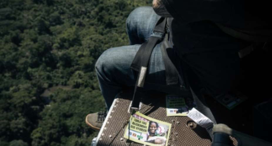 Caleb Weiss of the US-based Bridgeway Foundation drops leaflets over strongholds of the ADF rebel group in eastern Democratic Republic of Congo urging its fighters to surrender.  By ALEXIS HUGUET (AFP)