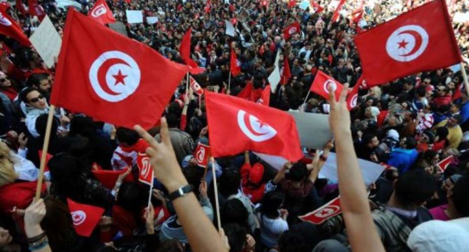 Flag-wavers chanted Liberty, dignity at the rally in Tunis.  By Fethi Belaid (AFP)