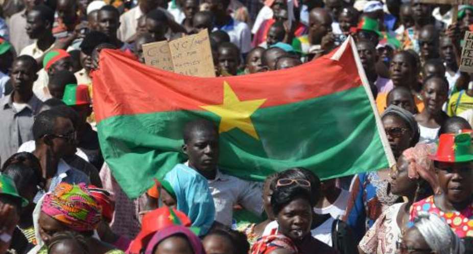 Residents take part in a march to protest against the cost of living in Ouagadougou, on October 29, 2014..  By Issouf Sanogo AFP
