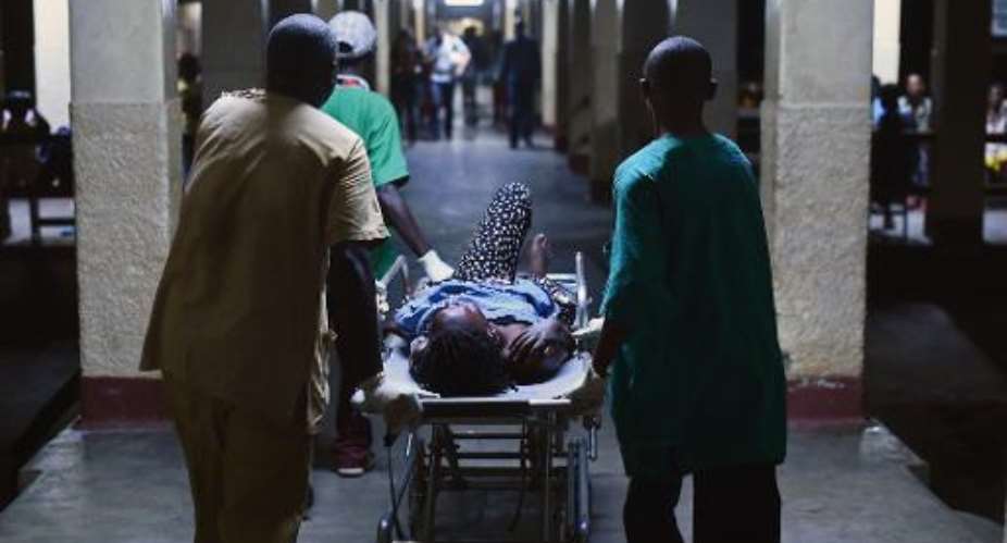 A woman is treated at hospital in Burundi's capital Bujumbura on May 22, 2015 after a double grenade attack by unknown assailants on a market in the city centre that killed three people.  By Carl De Souza AFP