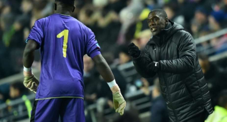 Cameroon coach Clarence Seedorf instructs goalkeeper Andre Onana during a 1-0 friendly loss to Brazil in England last November.  By Glyn KIRK AFPFile