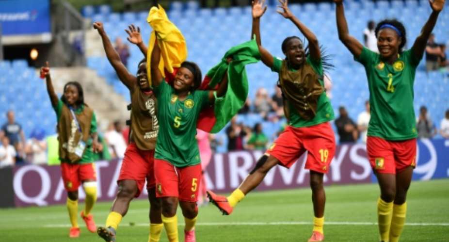 Cameroon players celebrate after Ajara Nchout's last-gasp goal saw them beat New Zealand to qualify for the last 16 of the women's World Cup on Thursday.  By Pascal GUYOT AFP