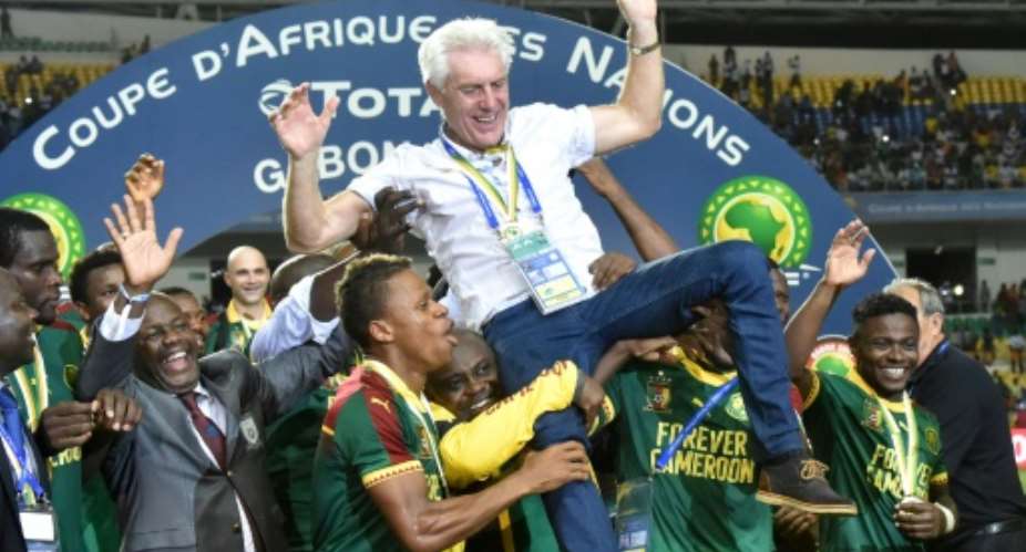 Cameroon players lift Cameroon's Belgian coach Hugo Broos as the celebrate after beating Egypt 2-1 to win the 2017 Africa Cup of Nations final football match between Egypt and Cameroon on February 5, 2017.  By ISSOUF SANOGO AFPFile
