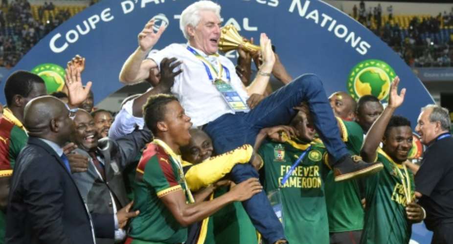 Cameroon team players lift Cameroon's Belgian coach Hugo Broos as the celebrate after beating Egypt 2-1 to win the 2017 Africa Cup of Nations final football match between Egypt and Cameroon on February 5, 2017.  By ISSOUF SANOGO AFP