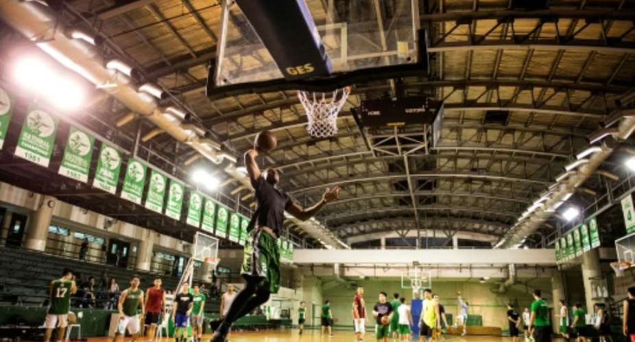 Cameroon's Benoit Mbala attempts a dunk during basketball practice at De La Salle University's gym in Manila on January 24, 2017.  By Noel CELIS AFPFile