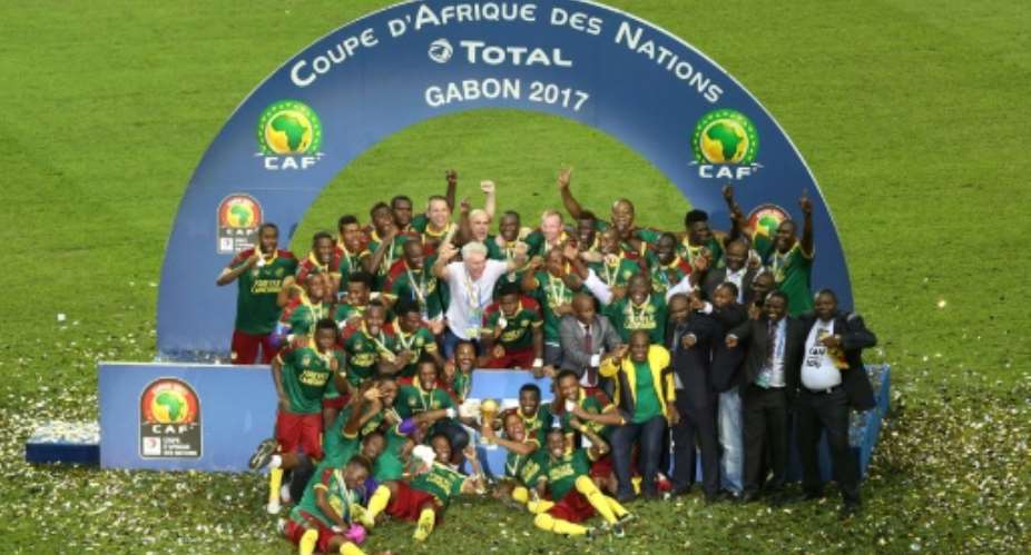 Cameroon's players celebrate with the trophy at the end of the 2017 Africa Cup of Nations final football match between Egypt and Cameroon at the Stade de l'Amitie Sino-Gabonaise in Libreville on February 5, 2017.  By Steve JORDAN AFP