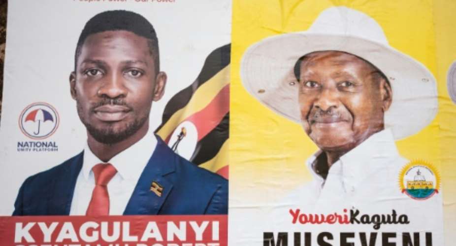 Campaign: Election posters for Bobi Wine, left, and President Yoweri Museveni.  By SUMY SADURNI AFP