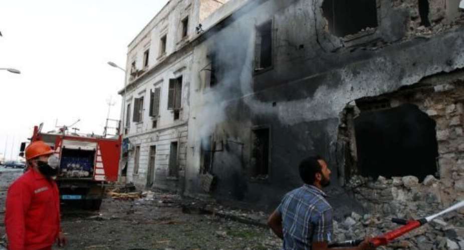 Firefighters extinguish a fire caused by a blast near a foreign ministry building in Benghazi on September 11, 2013.  By Abdullah Doma AFP