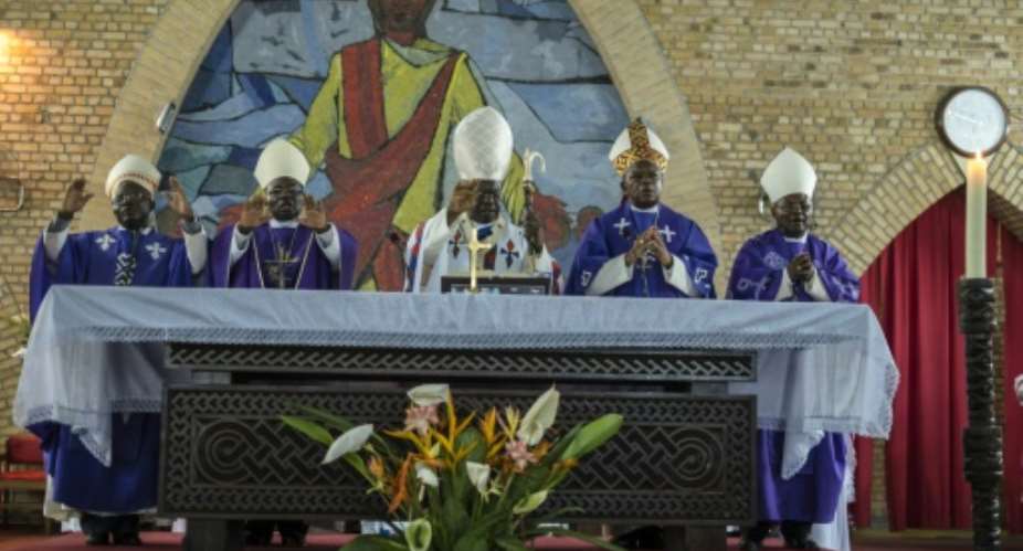 Cardinal Laurent Monsengwo Pasinya C, Archbishop of Kinshasa and a leading government critic, passed the baton to Fridolin Ambongo, who will take over as de facto leader of the Democratic Republic of Congo's powerful Catholic Church.  By EDUARDO SOTERAS AFP
