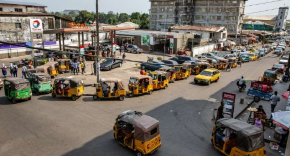 Cars and tuk-tuk taxis often need to wait for hours at fuel stations as Liberia experience petrol a shortage.  By Carielle Doe AFPFile