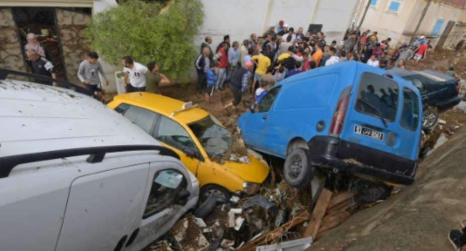 Cars piled up in a street after they were hit by flash floods in the city of Mohamedia near Tunisia's capital Tunis on October 18, 2018.  By FETHI BELAID AFP