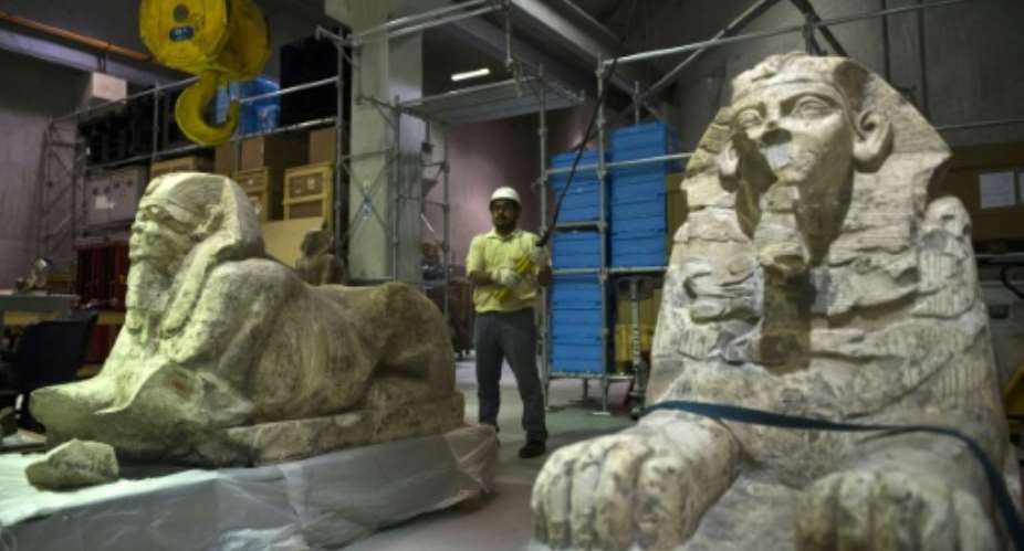Egyptian archaeologists move statues of pharaohs at the new Grand Egyptian Museum near the Giza pyramids in Cairo on June 4, 2015.  By Khaled Desouki AFPFile