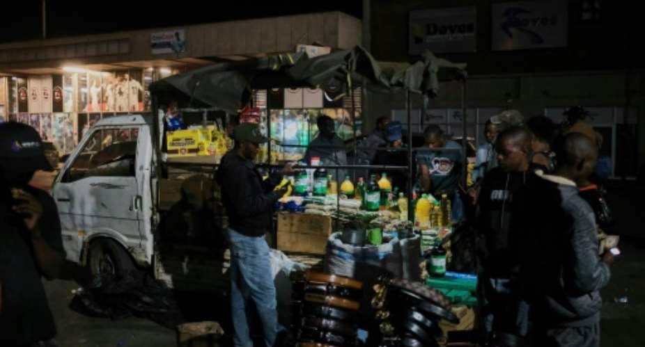 Cash-crunched Zimbabweans are increasingly turning to informal vendors for their groceries shopping.  By Jekesai NJIKIZANA AFP