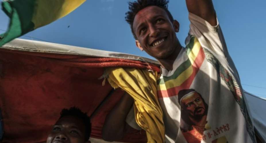 Celebrations: A man waves the Ethiopian imperial flag during an impromptu parade for freed opposition leaders in Alamata.  By EDUARDO SOTERAS AFP