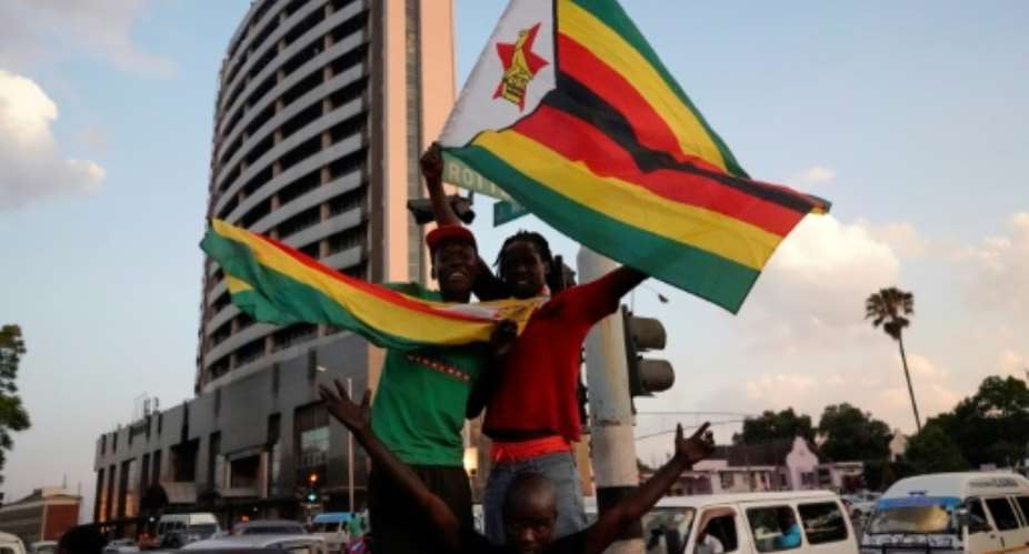 Celebrations erupt in the streets of Harare after the resignation of Zimbabwes veteran leader president Robert Mugabe.  By Marco Longari (AFP)