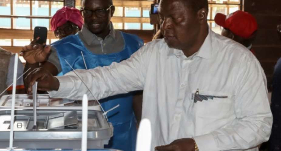 Central African Republics President and presidential candidate for the United Hearts Movement (MCU) Faustin Archange Touadera casts his ballot at a polling station in Bangui on December 28, 2025 during Central African Republics presidential election..  By Annela NIAMOLO (AFP)