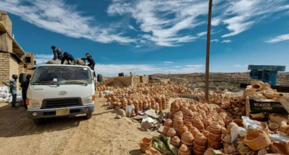 Ceramic pots are loaded onto a truck in front of a workshop in the Libyan town of Gharyan, 100 km 60 miles southwest of the capital Tripoli.  By Mahmud TURKIA AFP