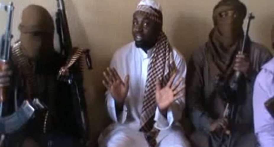 A screengrab taken from a video released on You Tube apparently shows Boko Haram leader Abubakar Shekau (C).  By  (AFP/YouTube/File)