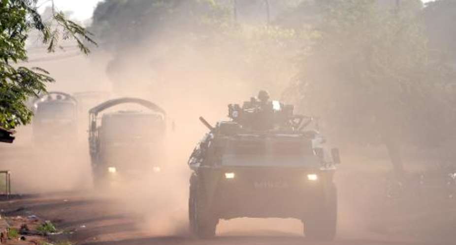 A convoy of African-led International Support Mission to the Central African Republic vehicles escorts Chadian soldiers out of Bangui on April 4, 2014.  By Miguel Medina AFPFile