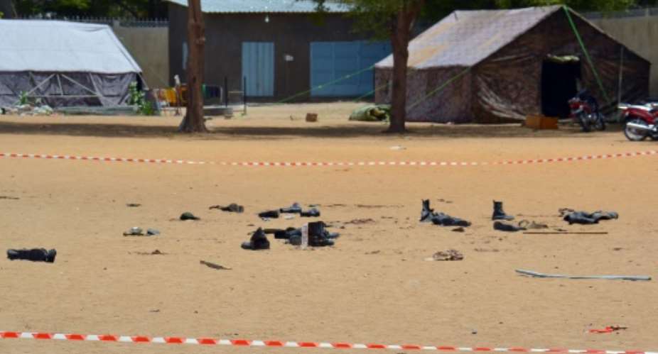 Boots of people killed in a suicide bomb attack outside the police headquarters in N'Djamena, on June 15, 2015.  By Brahim Adji AFPFile