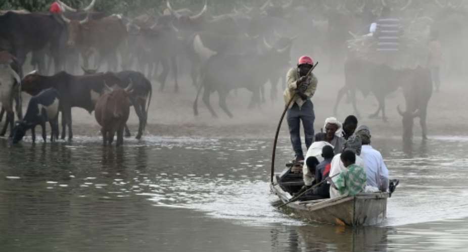 People use a boat to cross Lake Chad, where hundreds of islets separated by channels hidden by tall grass provides cover for Boko Haram to steal livestock and crops from locals.  By Philippe Desmazes AFPFile