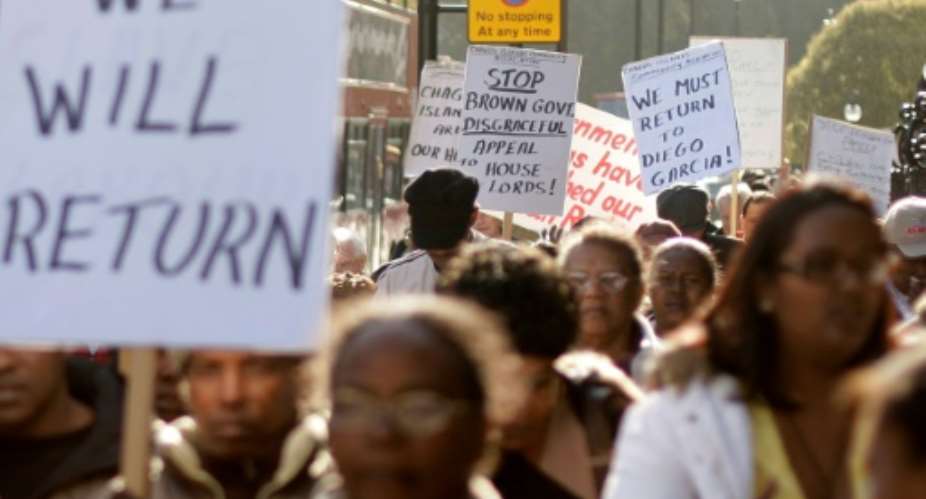 Chagos Islanders leave Londons Houses of Parliament with protest signs on October 22, 2008.  By SHAUN CURRY (AFP/File)