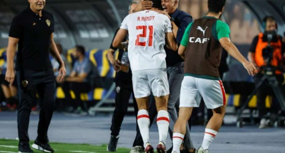 Championship winner: Ahmed Hamdy (C) celebrates with Zamalek coach Jose Gomes (2R).  By Khaled DESOUKI (AFP)