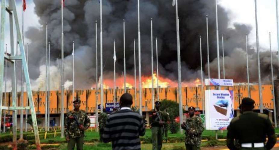 General Service GSU officers outside the burning Jomo Kenyatta international airport in Nairobi on August 7, 2013.  By  AFP
