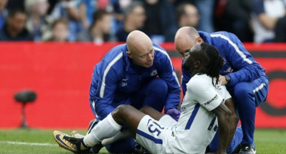 Chelsea's Nigerian midfielder Victor Moses receives treatment for an injury during the English Premier League football match against Crystal Palace at Selhurst Park in south London on October 14, 2017.  By Ian KINGTON AFPFile