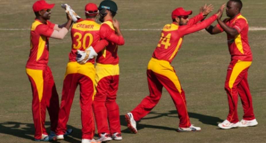 Zimbabwe players celebrate a wicket during the second in a series of two Twenty20 international cricket matches between Zimbabwe and India at the Harare Sports Club on July 19, 2015.  By Jekesai Njikizana AFP