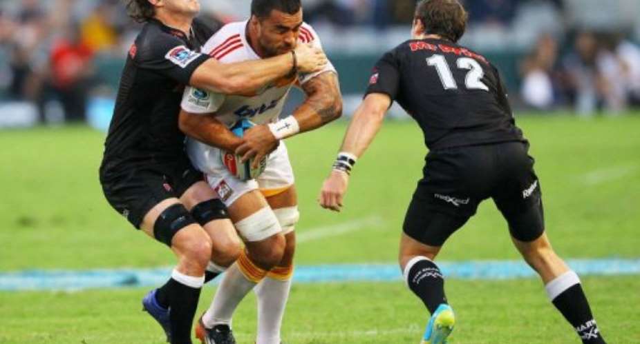 New Zealand Waikato Chiefs' Liam Messam C is tackled by Durban Sharks' Keegan Daniels.  By  AFP