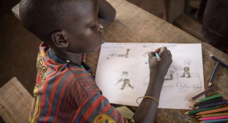 Children at the Lazare camp in Central African Republic are encouraged to draw as a form of therapy for post-traumatic stress disorder.  By FLORENT VERGNES AFP