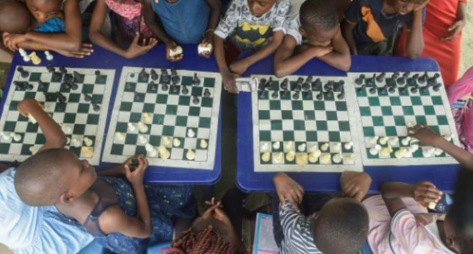 Children in a Lagos slum are being taught chess under a project aimed at bringing them hope and confidence.  By PIUS UTOMI EKPEI AFP