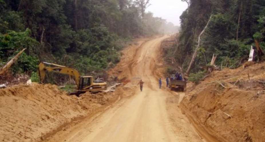 Heavy earthmoving equipment works in 2010 on a 75km strategic dirt road built by the Cameroon army.  By  AFPFile