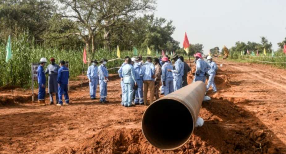 Chinese and Nigerien workers are building a huge pipeline that will take crude oil from Niger to a port in Benin.  By BOUREIMA HAMA (AFP)