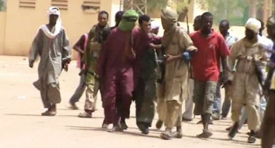 A still from a video shows Islamist fighters walking in the streets of Gao in June 2012.  By  (AFP/File)