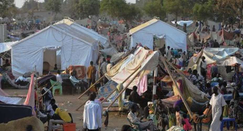 People gather at a makeshift IDP camp at the United Nations Mission in South Sudan compound in Juba on December 22, 2013.  By Tony Karumba AFPFile