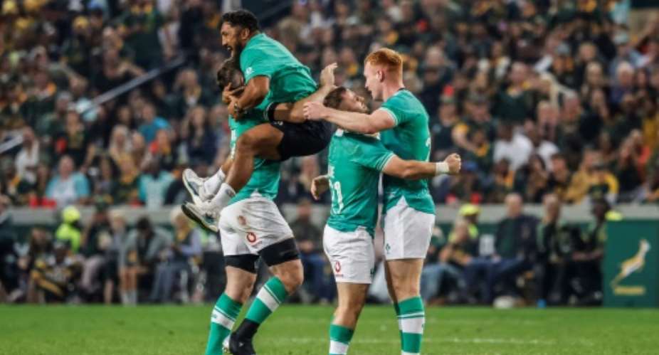 Ciaran Frawley (R) celebrates Irelands win.  By WIKUS DE WET (AFP)
