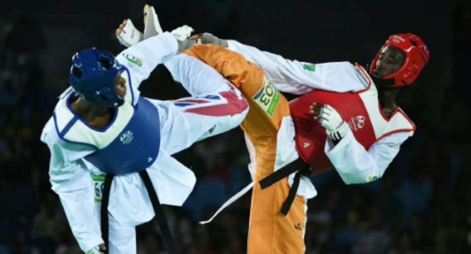 Ivory Coast's Cheick Sallah Cisse R created history for the West African country when he stunned Britain's Lutalo Muhammad with a four-point score for Olympic gold right at the end in the men's -80kg taekwondo.  By Ed Jones AFP
