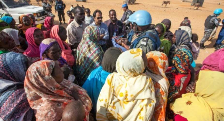 Displaced Sudanese women discuss their concerns with UNAMID personnel at Zam Zam camp for internally displaced people in North Darfur on February 18, 2014.  By Hamid Abdulsalam UNAMIDAFPFile