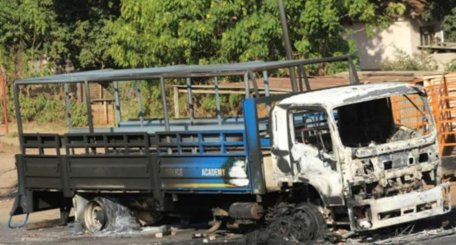 Clashes: A burned-out Police Academy truck in the city of Manzini.  By - AFPFile