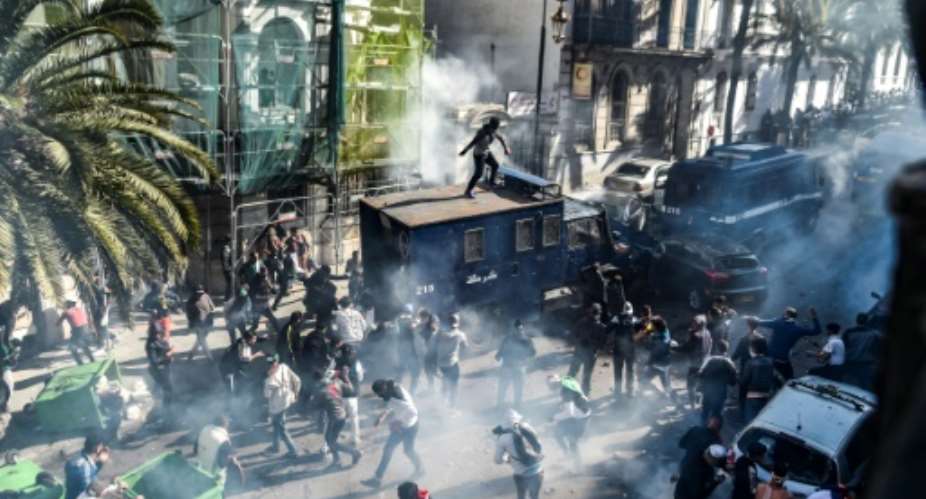 Clashes erupt between Algerian protesters and riot police during a  demonstration in Algiers, the eighth Friday in a row that protestors have taken to the streets.  By RYAD KRAMDI AFP