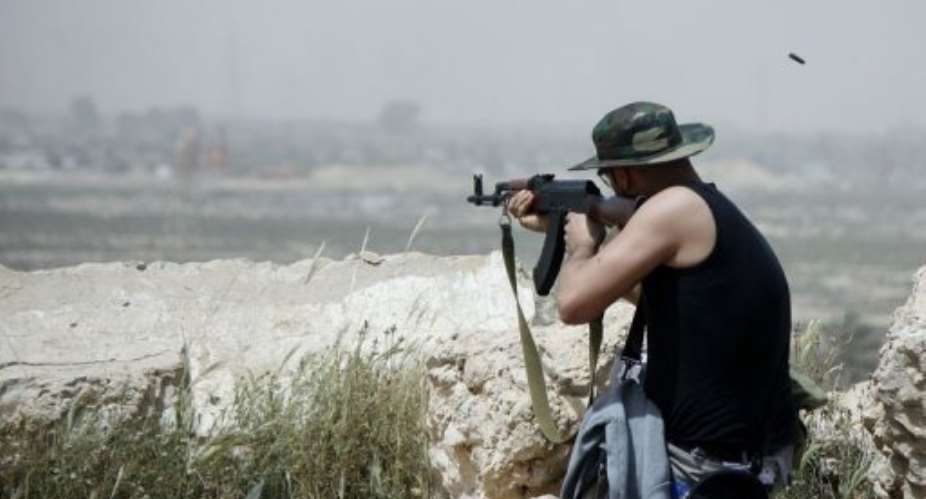 A Zuwarah fighter fires his weapon.  By Imed Lamloum AFP