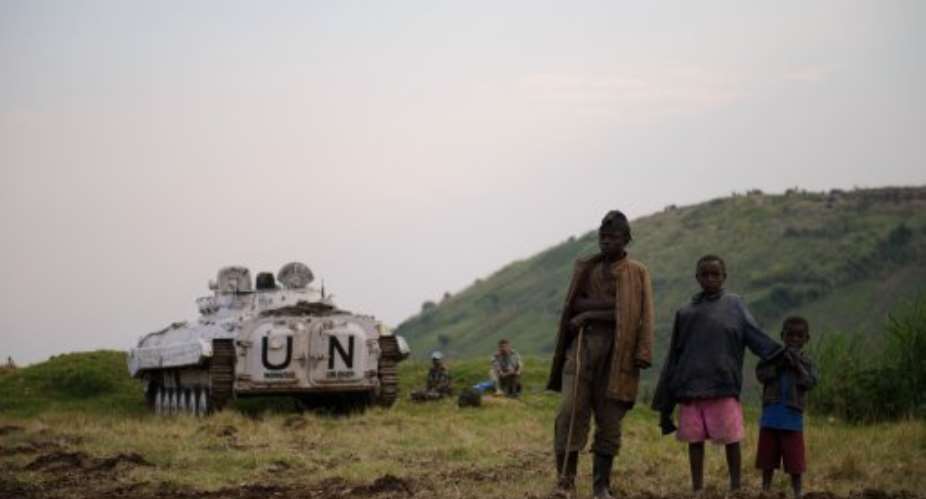 Congolese stand near a United Nations armoured infantry combat vehicle.  By Phil Moore (AFP/File)