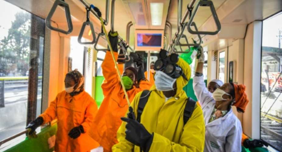 Cleaning staff disinfect a metro carriage in Addis Ababa -- Ethiopia announced its first COVID-19 deaths Sunday.  By Michael Tewelde AFP