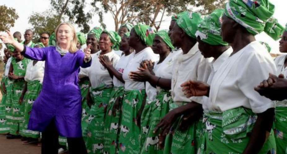 US Secretary of State Hillary Clinton L dances with Malawian women.  By Amos Gumulira AFP
