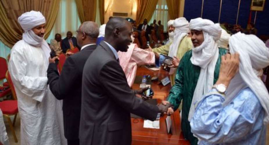 Members of the Malian and Tuareg delegations, after signing an agreement on June 18, 2013 in Ouagadougou.  By Ahmed Ouoba (AFP/File)