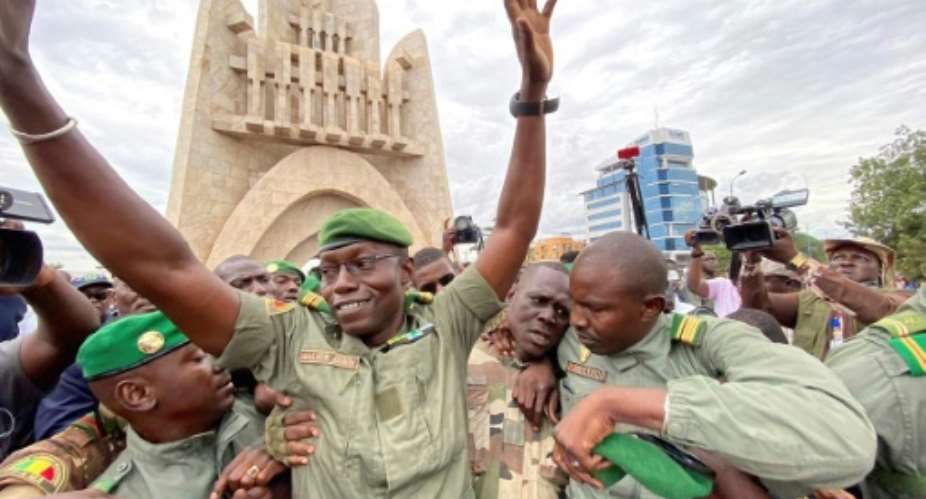 Col. Malick Diaw, deputy head of the new junta, greeted the crowd celebrating in Bamako's Independence Square.  By MALIK KONATE AFP